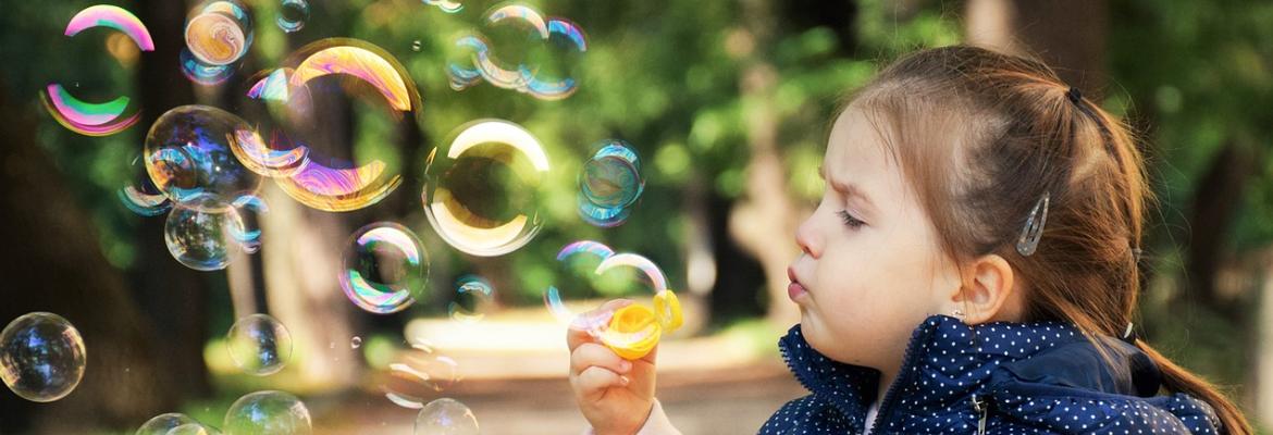 child blowing bubbles